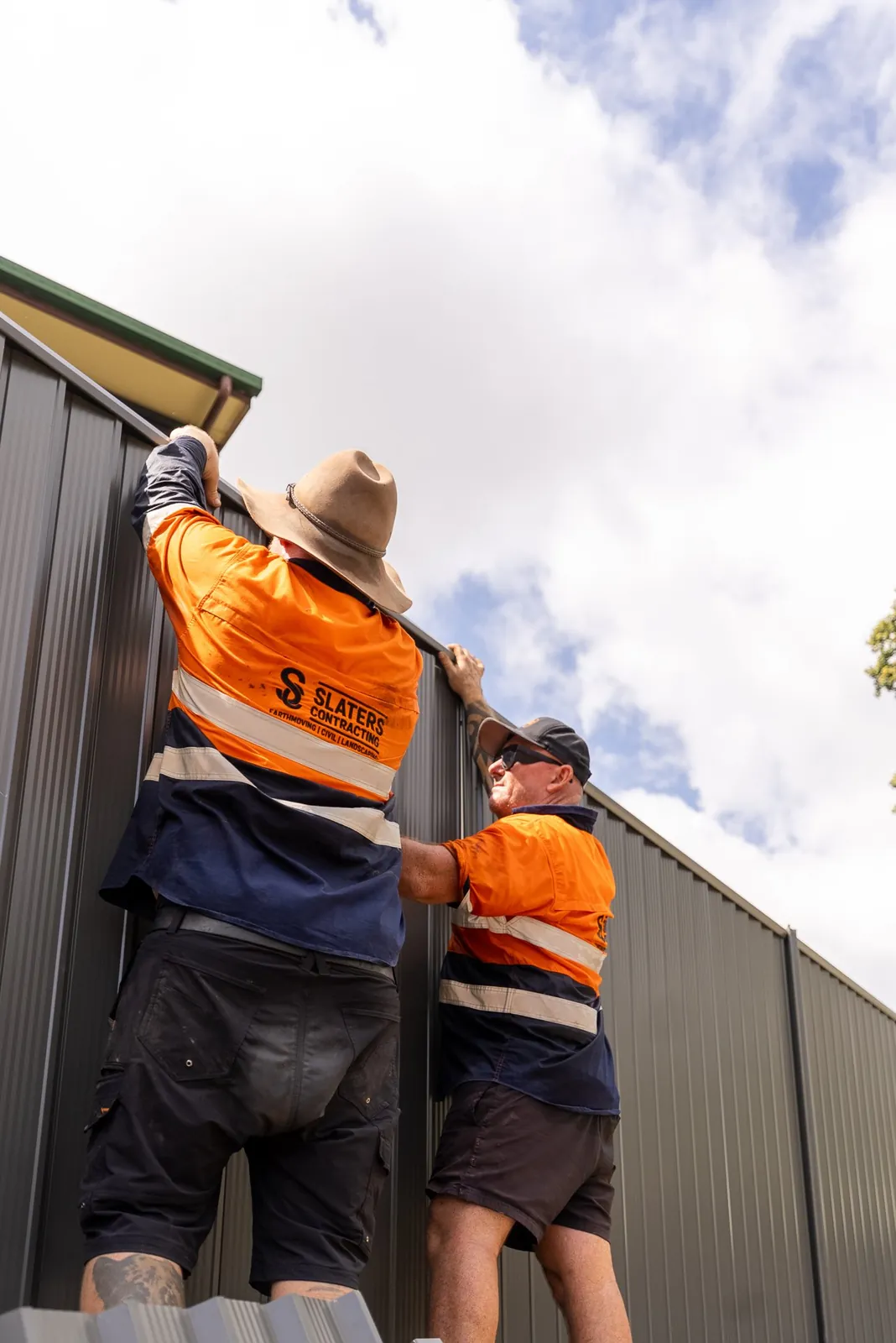 Two of the crew installing a Colorbond fence