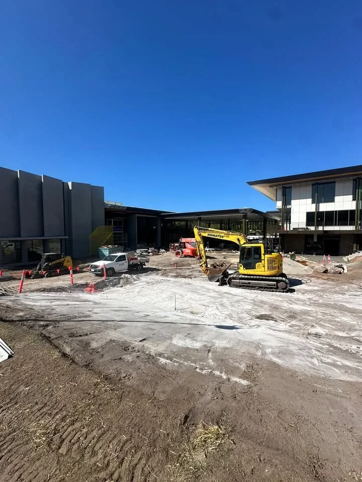Excavator, posi track and ute on a commercial building site
