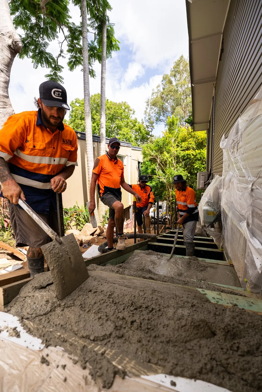 The crew forming and pouring a concrete path
