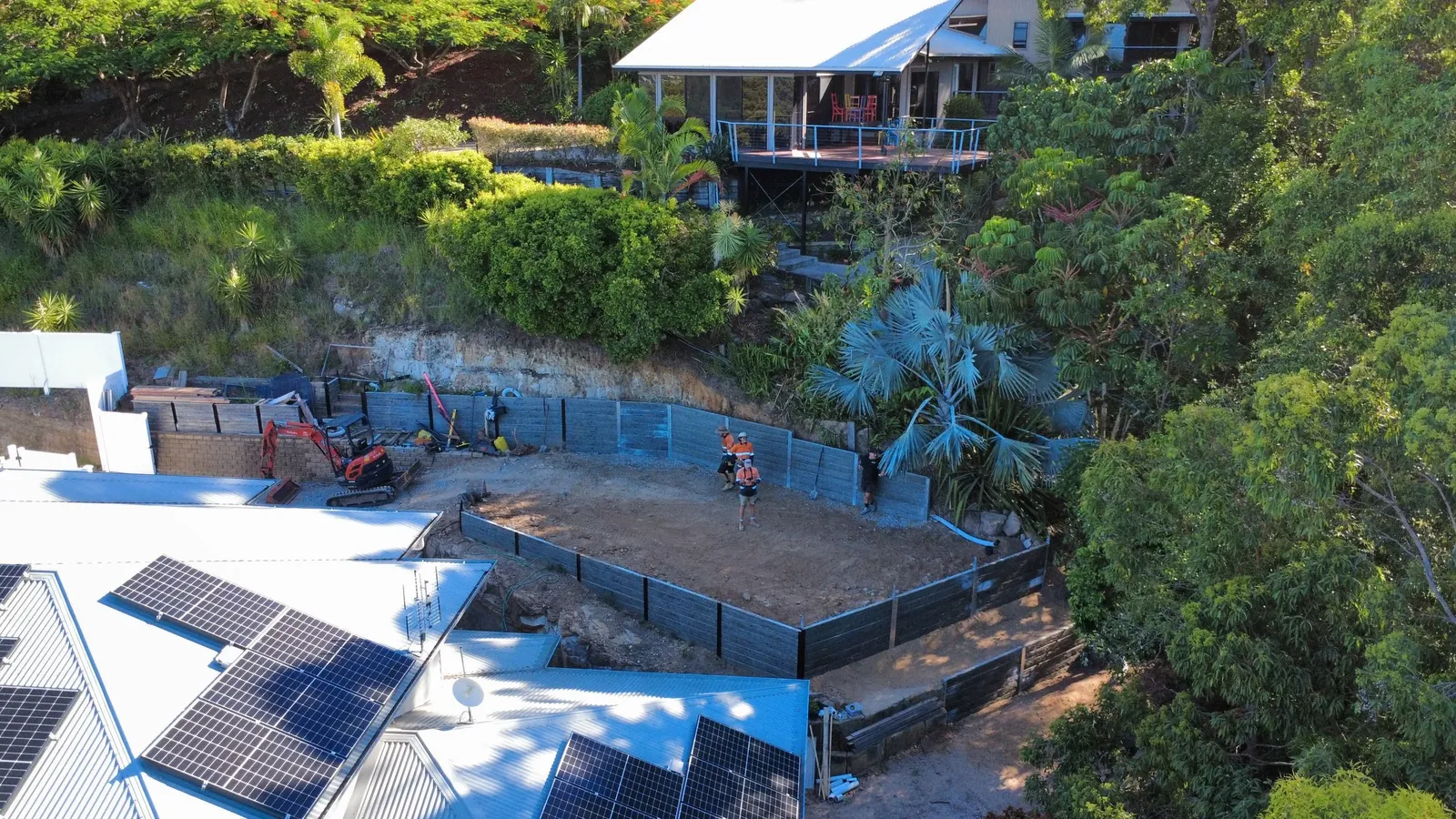 Drone view of a backyard excavation with new retaining walls
