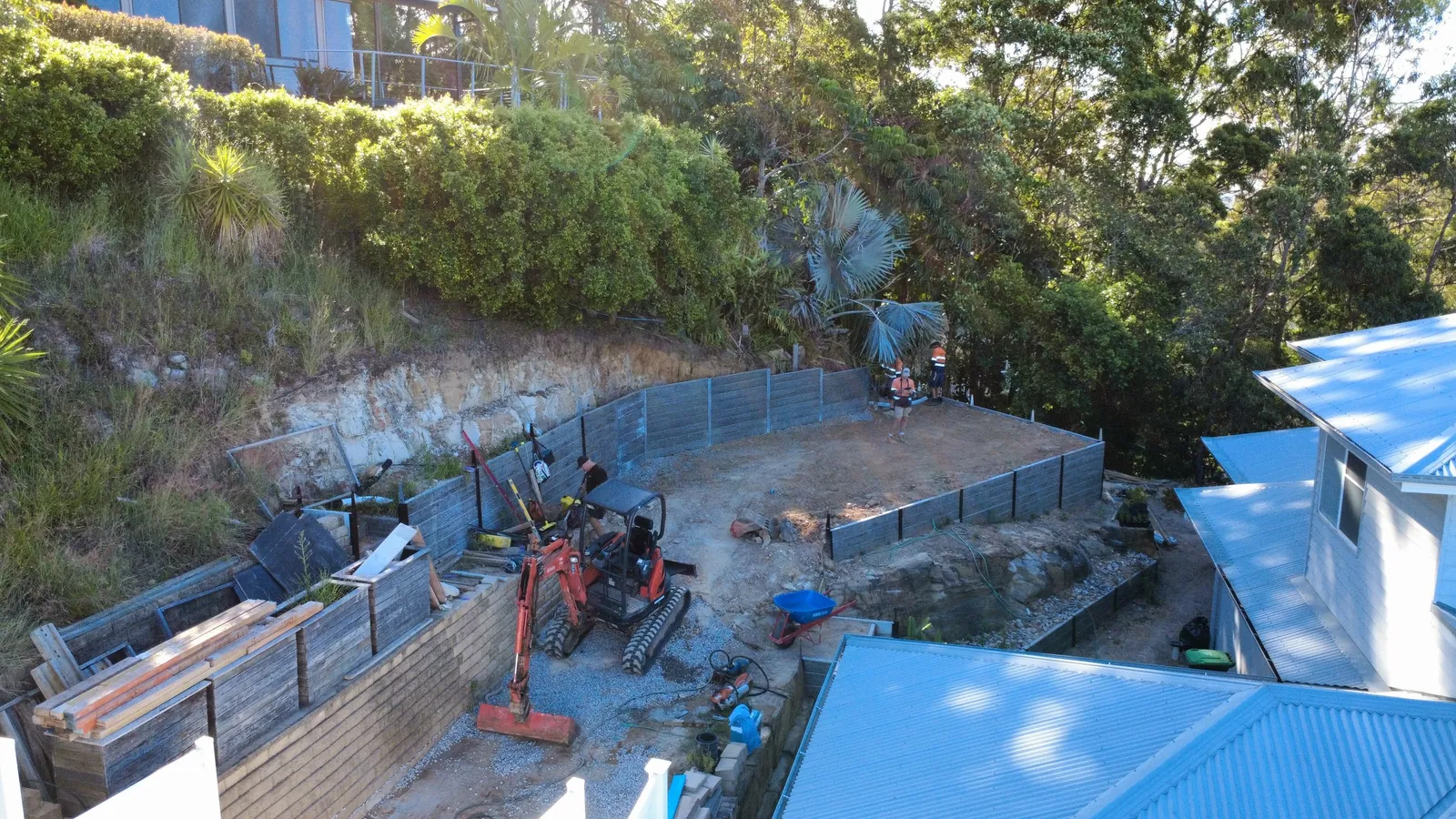 Drone view of old timber walls being dug out before the new concrete sleeper walls went in
