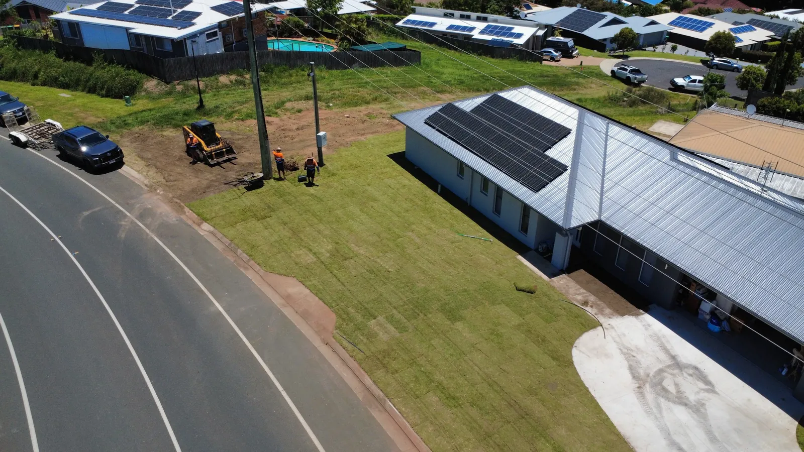 Drone view of finished turf beside a new home