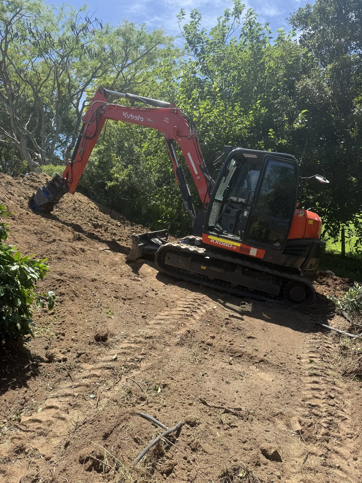 Excavator working on a sloping block