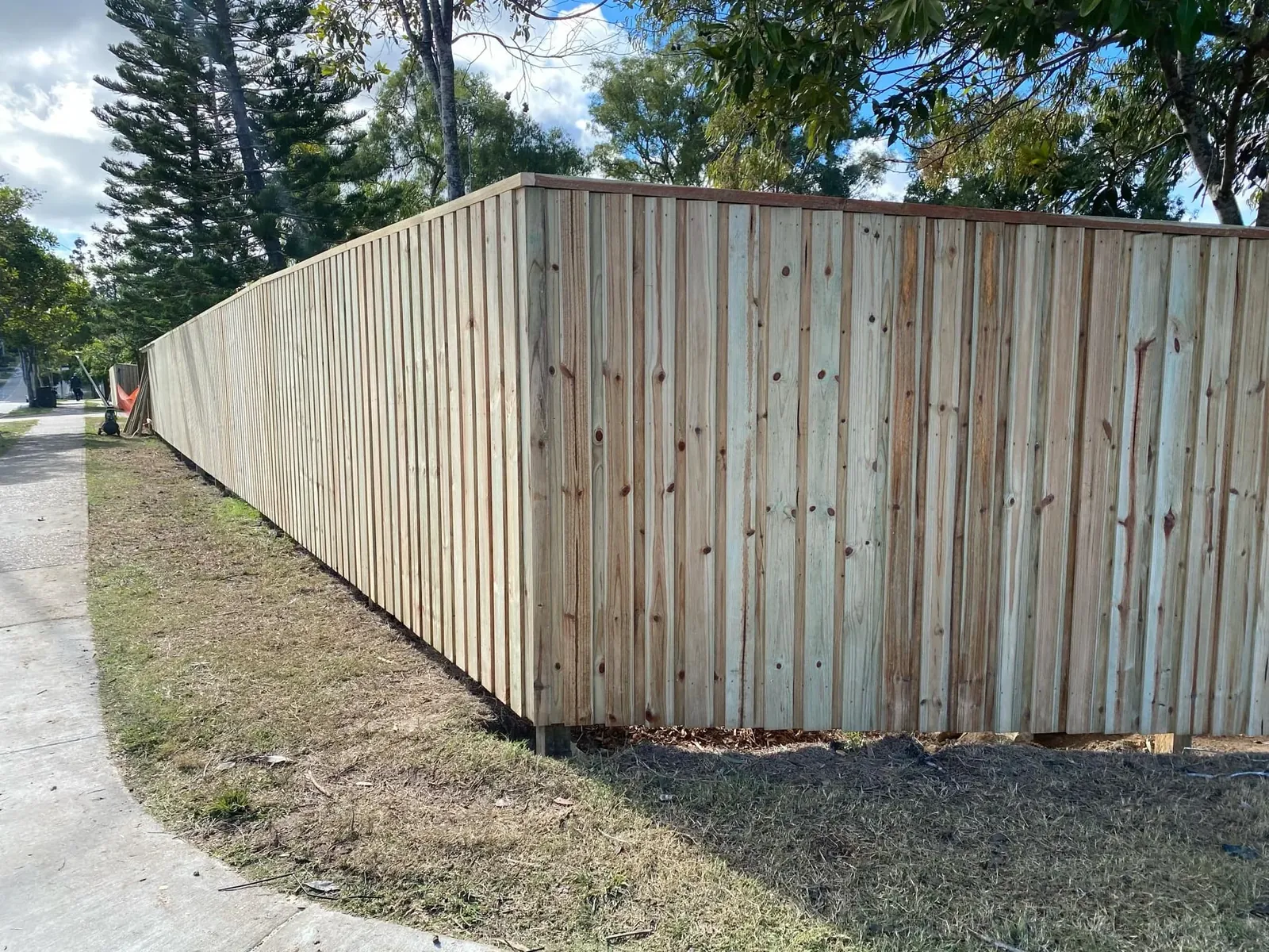 A new timber paling fence along a boundary