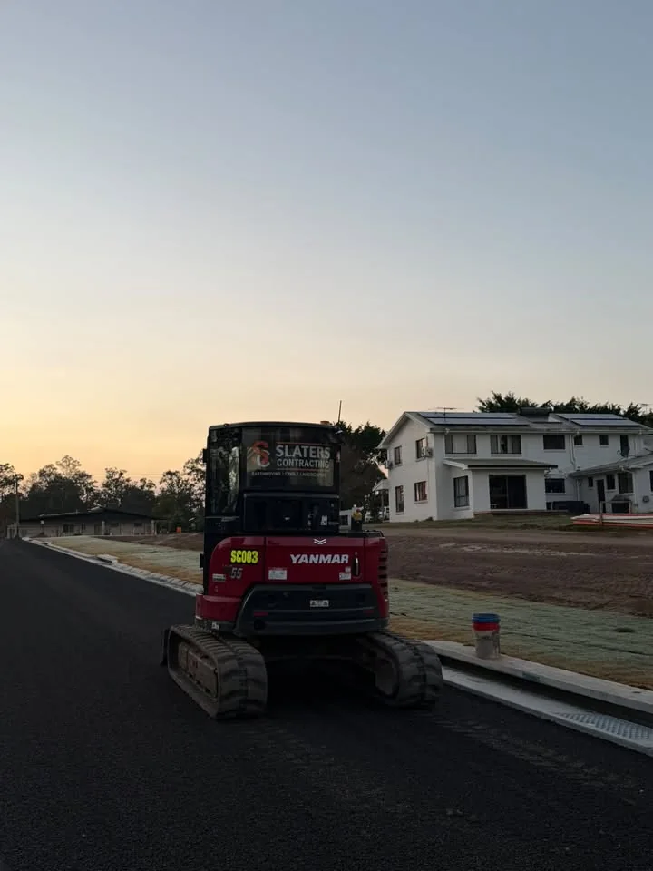 Slaters Yanmar mini excavator on a new subdivision road at sunset
