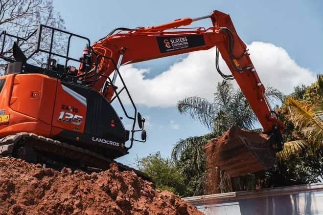 Zaxis 135 excavator digging from the top of a spoil pile